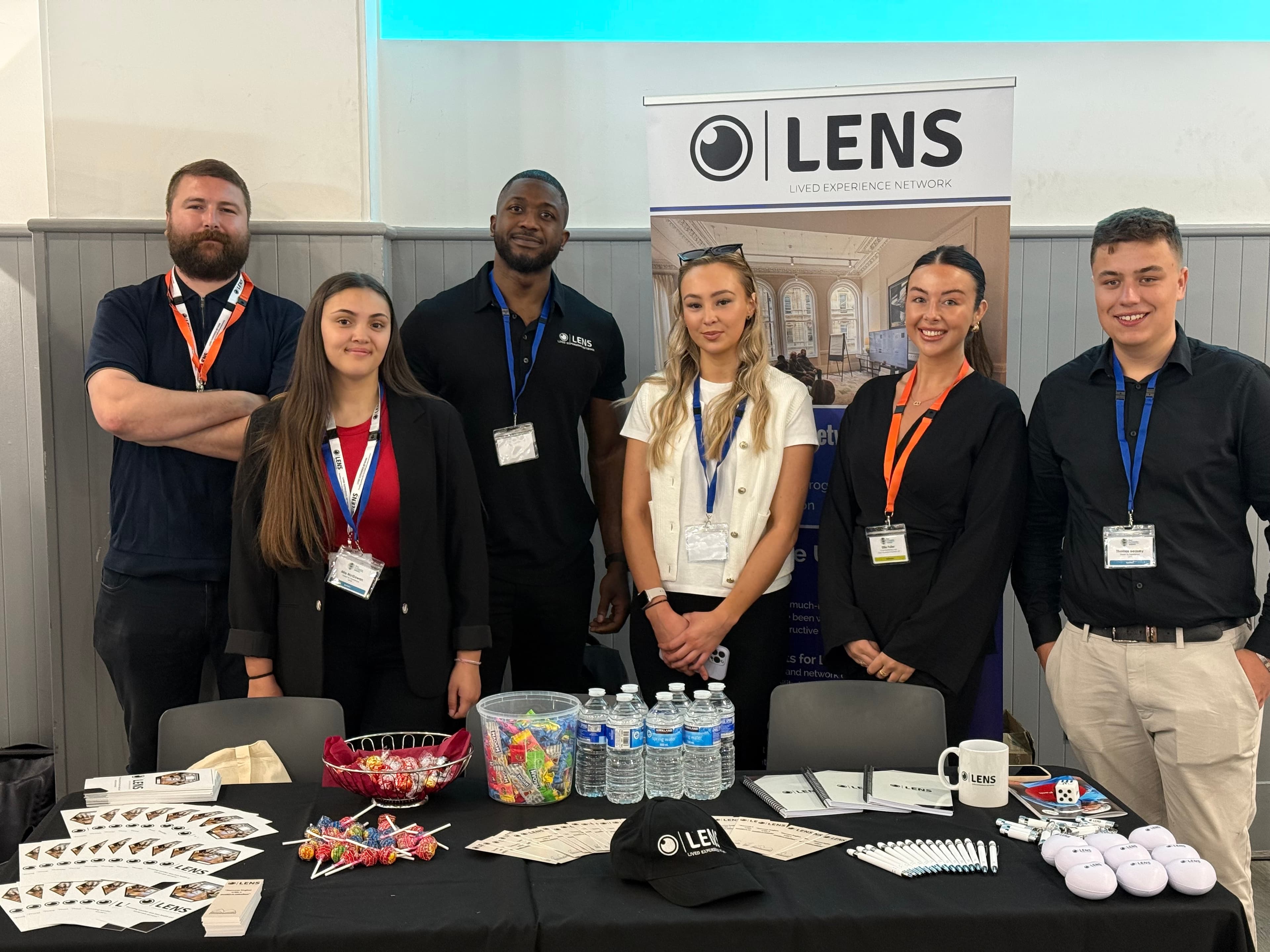 Members of the LENs team at a conference stand.